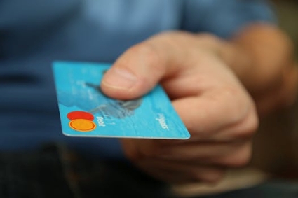 A man grips a credit card