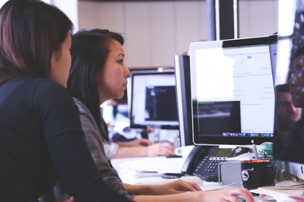 Two women working on a desktop