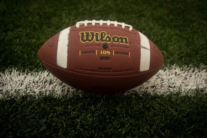 Close up of a football resting on the grass field