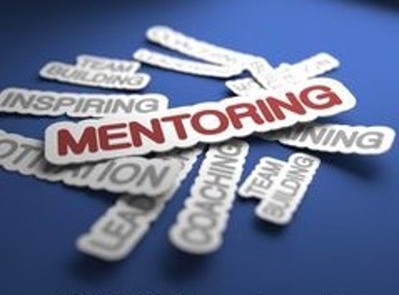 Graphic blue image reading, "Mentoring" with other words in the background like "Inspiring", "Team Building", "Coaching," etc