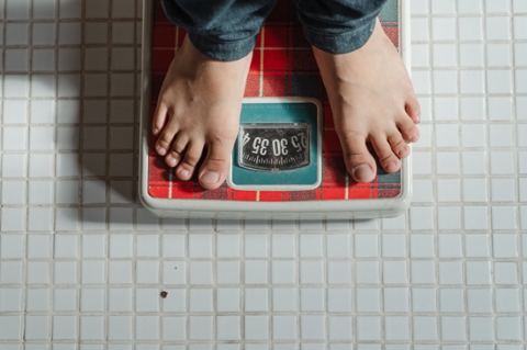 A person standing on a weighing scale